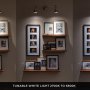 GU10 MiLight smart LED bulbs in a wall mount track light fixture above framed pictures showing tunable white CCT from 2700K to 6500K