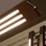 MICRO-NK silver aluminum LED strip channels installed as bathroom vanity task lighting in a custom wood fixture