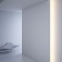 KLUS NISA-KRA aluminum channel fixtures lighting a room from inside a recessed drywall niche 