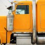 Amber low-profile Peterbilt-style LED truck clearance or side marker lights installed on a semi-truck