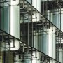 KLUS REGULOR aluminum channel fixtures illuminating frosted glass panels on a building exterior 
