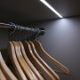 TAMI aluminum channel fixture with a frosted lens flush mounted in a wardrobe