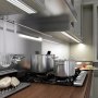 Under cabinet TRIADA aluminum channel fixtures illuminating a kitchen counter and stove