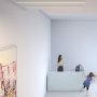 Ceiling-mounted TRIADA aluminum channel fixtureslighting a lobby