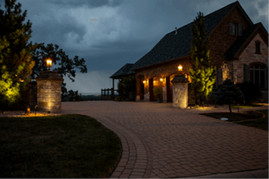 Large brick house with exterior lighting